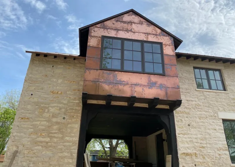 Copper metal panel facade on a stone building for Skylight Installation in Snellville