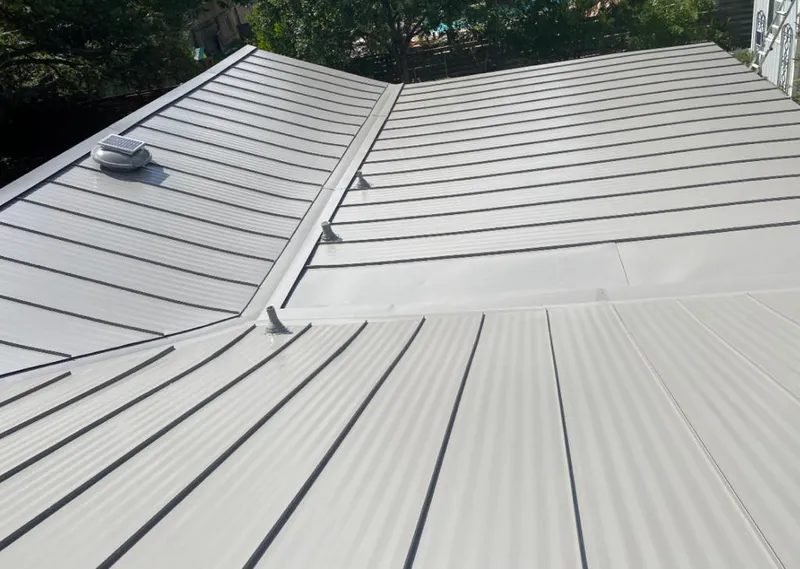 Solar attic fan installed on a metal roof for Roof Ventilation in Snellville